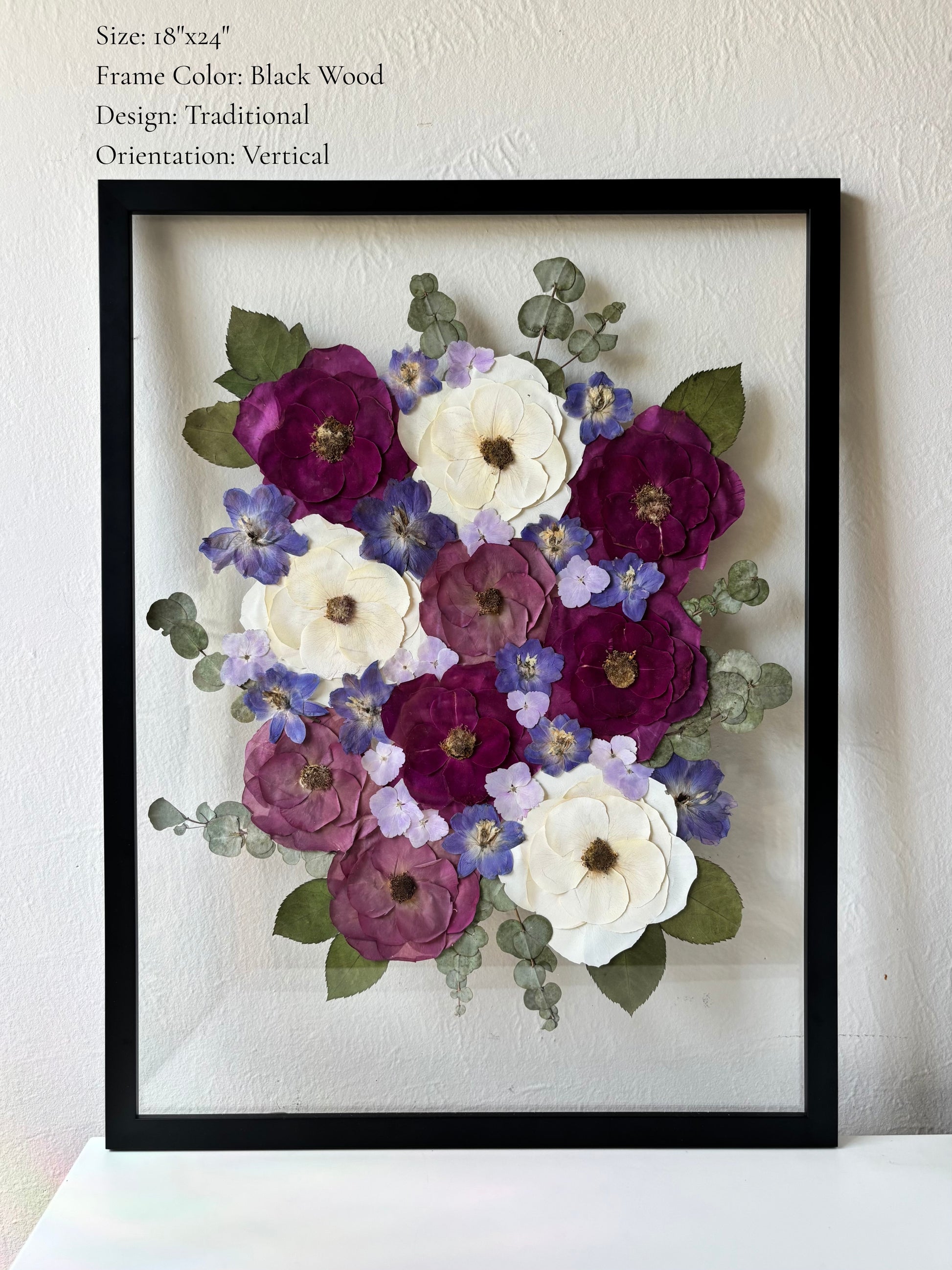 Custom bridal bouquet pressed flowers framed in glass with black wooden frame. White and purple pressed wedding bouquet. 