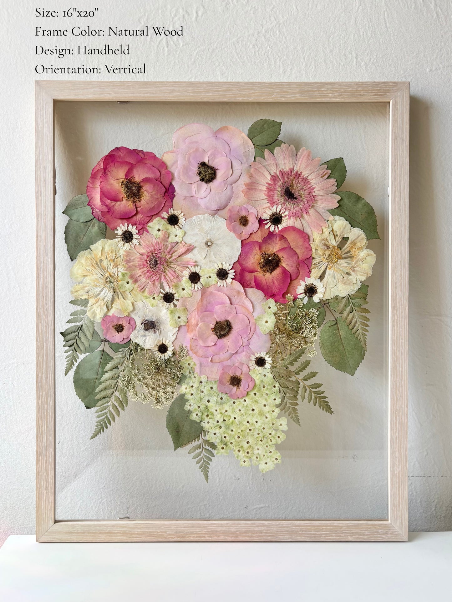 Pressed wedding bouquet preserved in a floating glass frame made of natural wood.