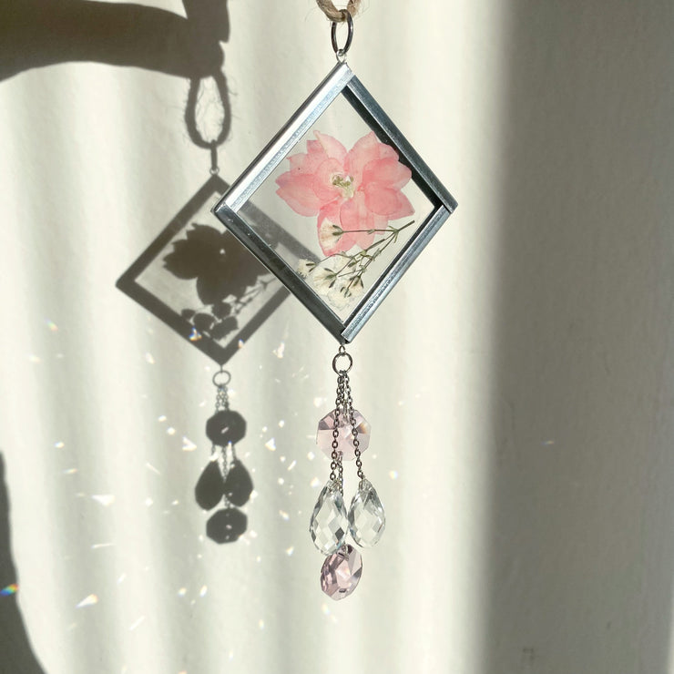 Pink car decor. A handmade sun catcher with a pink  real pressed flowers, and clear and pink crystals.