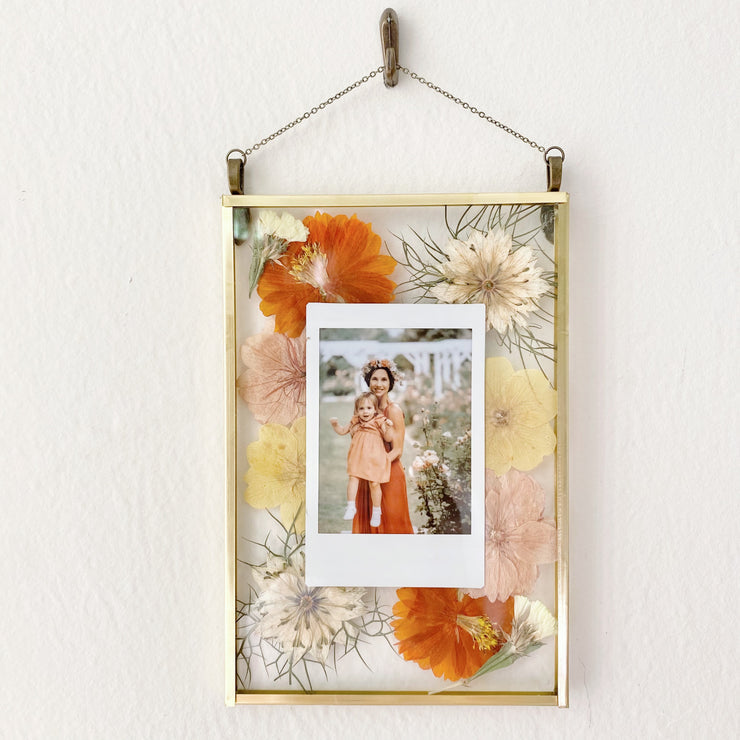 A polaroid pressed flower frame with a picture of mom and baby. A gift for her.