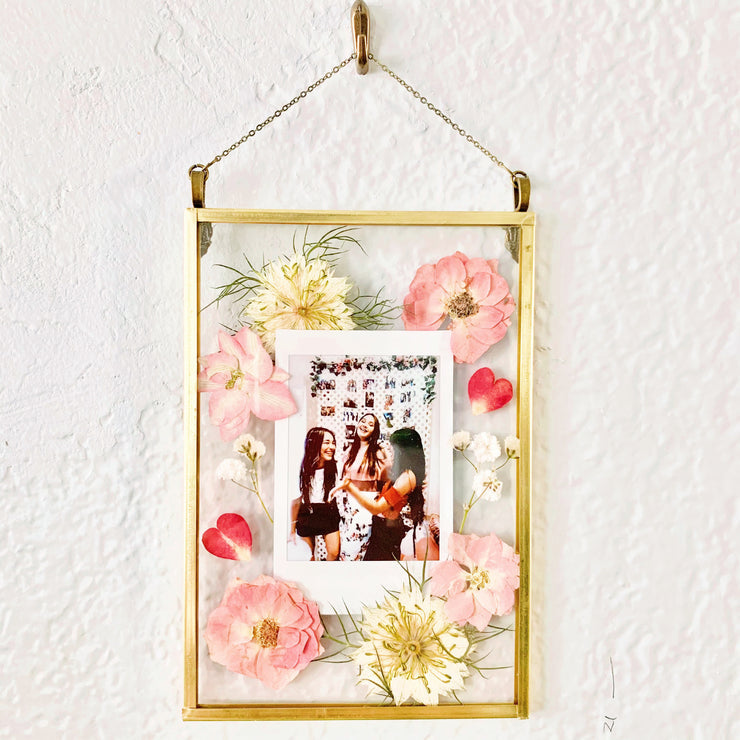 A polaroid pressed flower frame with a picture of best friends together. A gift for your best friend.