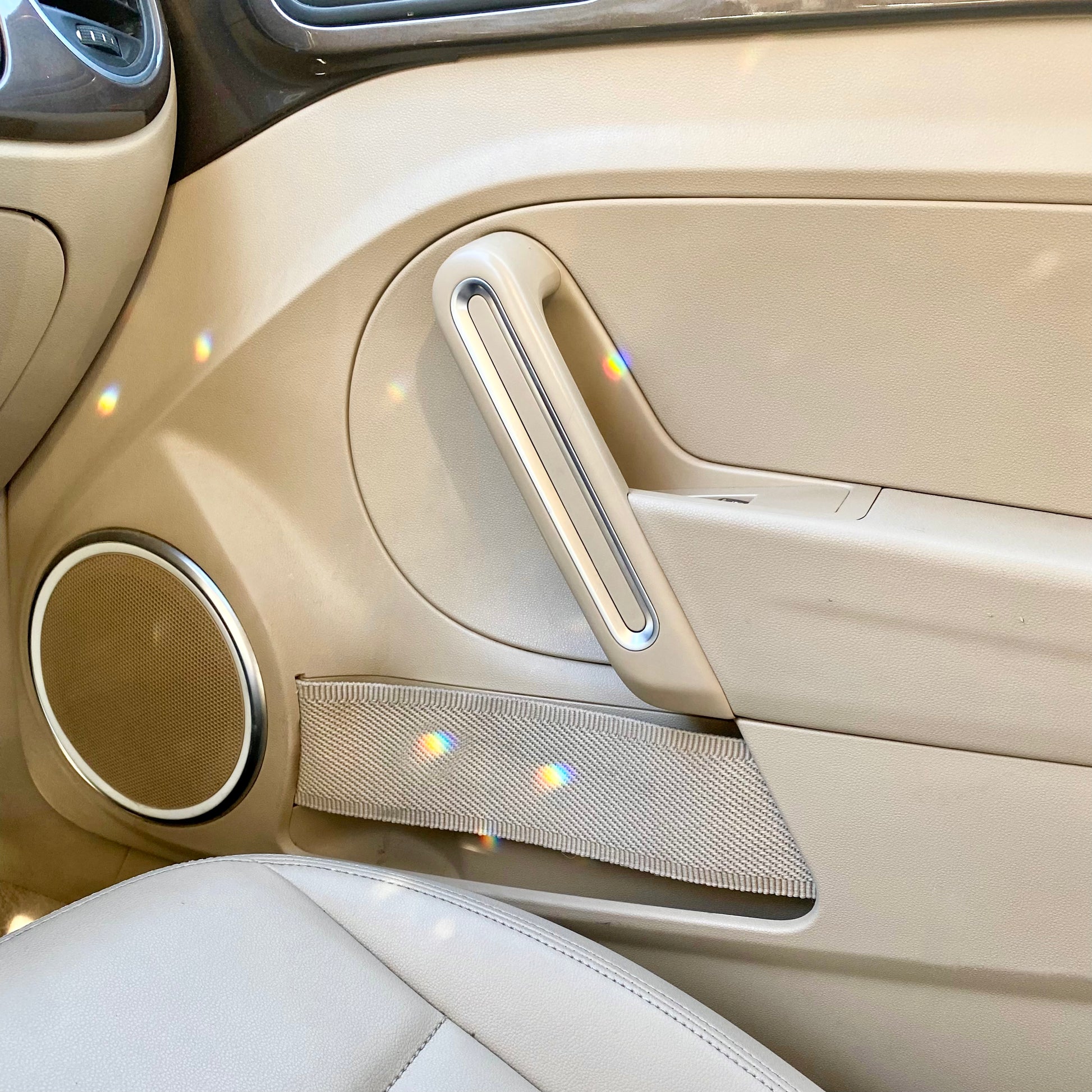 Girly car decor. Sun catcher making rainbows in car interior.